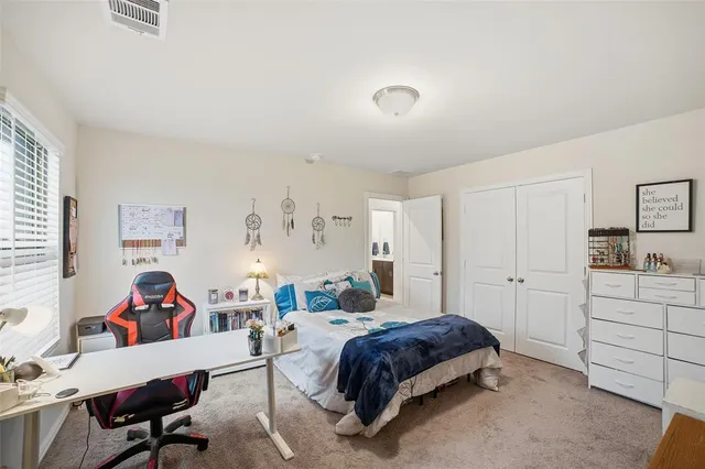 a bedroom with a bed and a desk