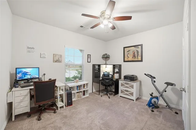a view of a livingroom with workspace and a window
