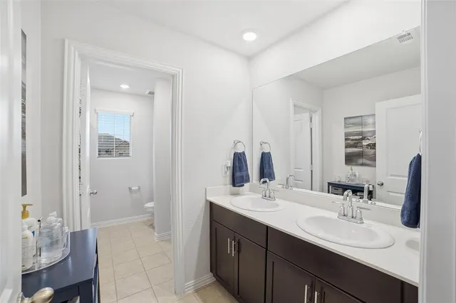 a bathroom with a sink double vanity and a mirror