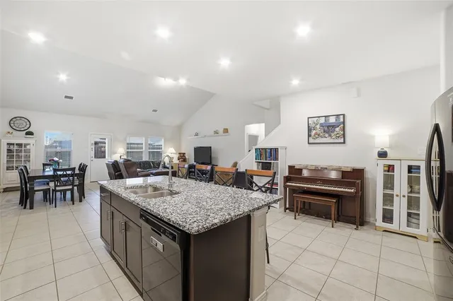 a kitchen with stainless steel appliances granite countertop a stove and a refrigerator
