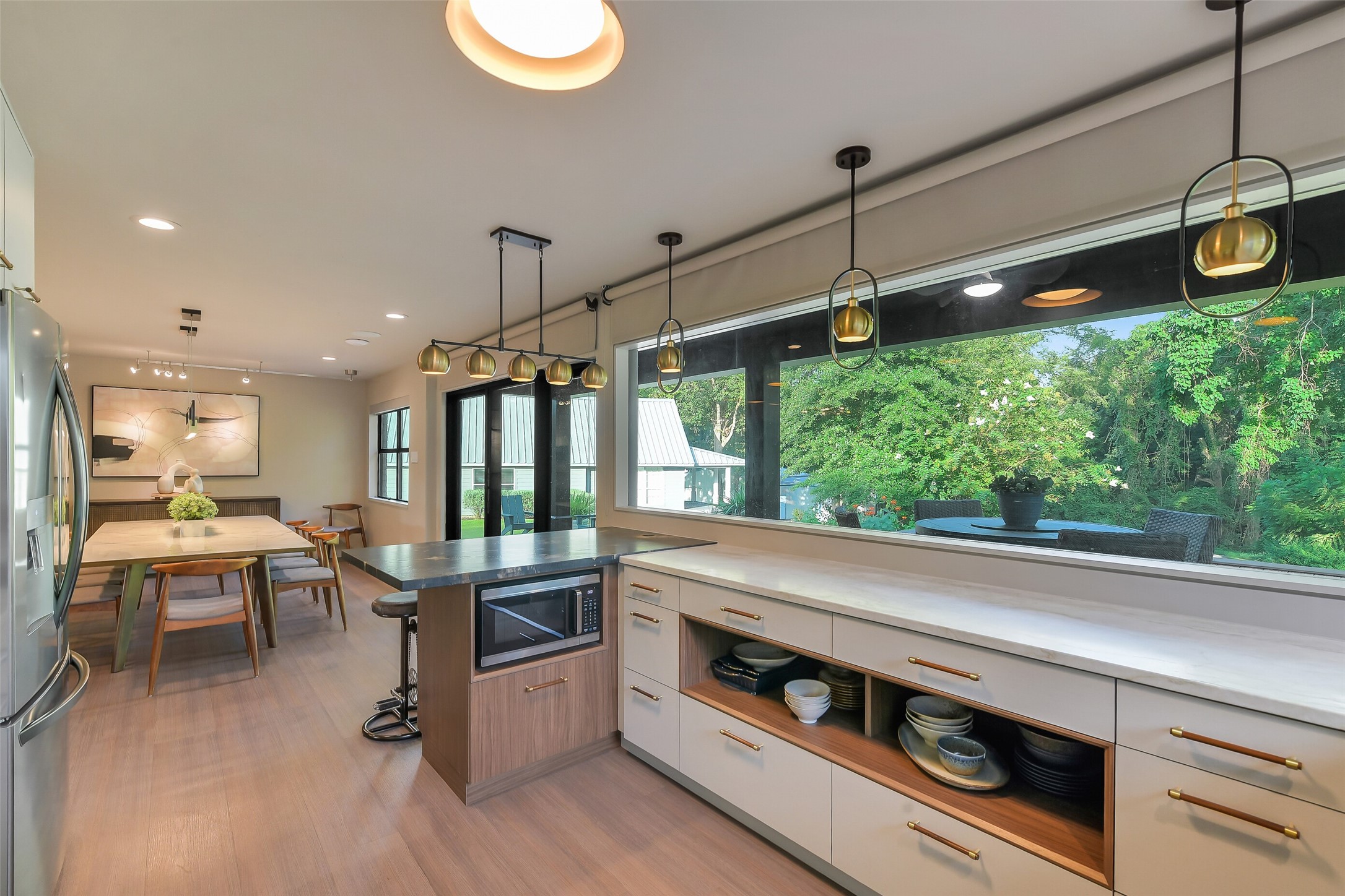 0 Camilla Lake Road Coldspring, TX 77331 - Photo 13 of 50 Brick House:The renovated kitchen flows seamlessly into the dining area, combining custom cabinetry, generous workspace and dramatic windows for effortless everyday living and entertaining!