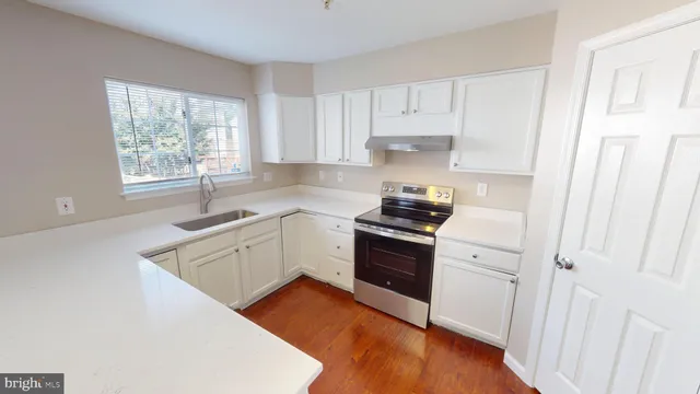 an aerial view of residential house with parking