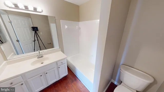an empty room with wooden floor and a window