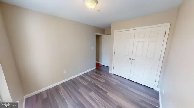 a kitchen with wooden floors and white walls