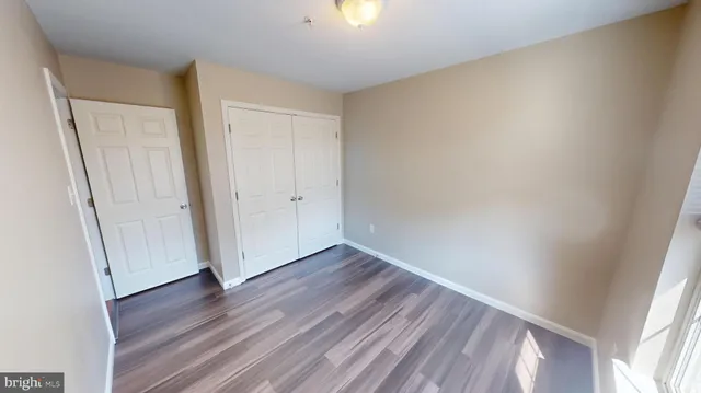 a view of hallway with wooden floor