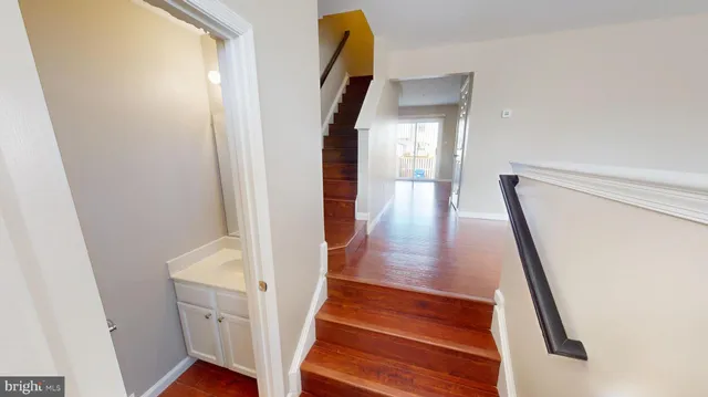 a view of entryway and hall with wooden floor