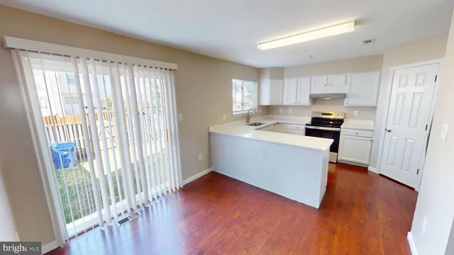 a room with furniture and kitchen view