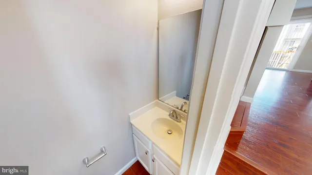 a view of a bathroom with a sink and wooden floor
