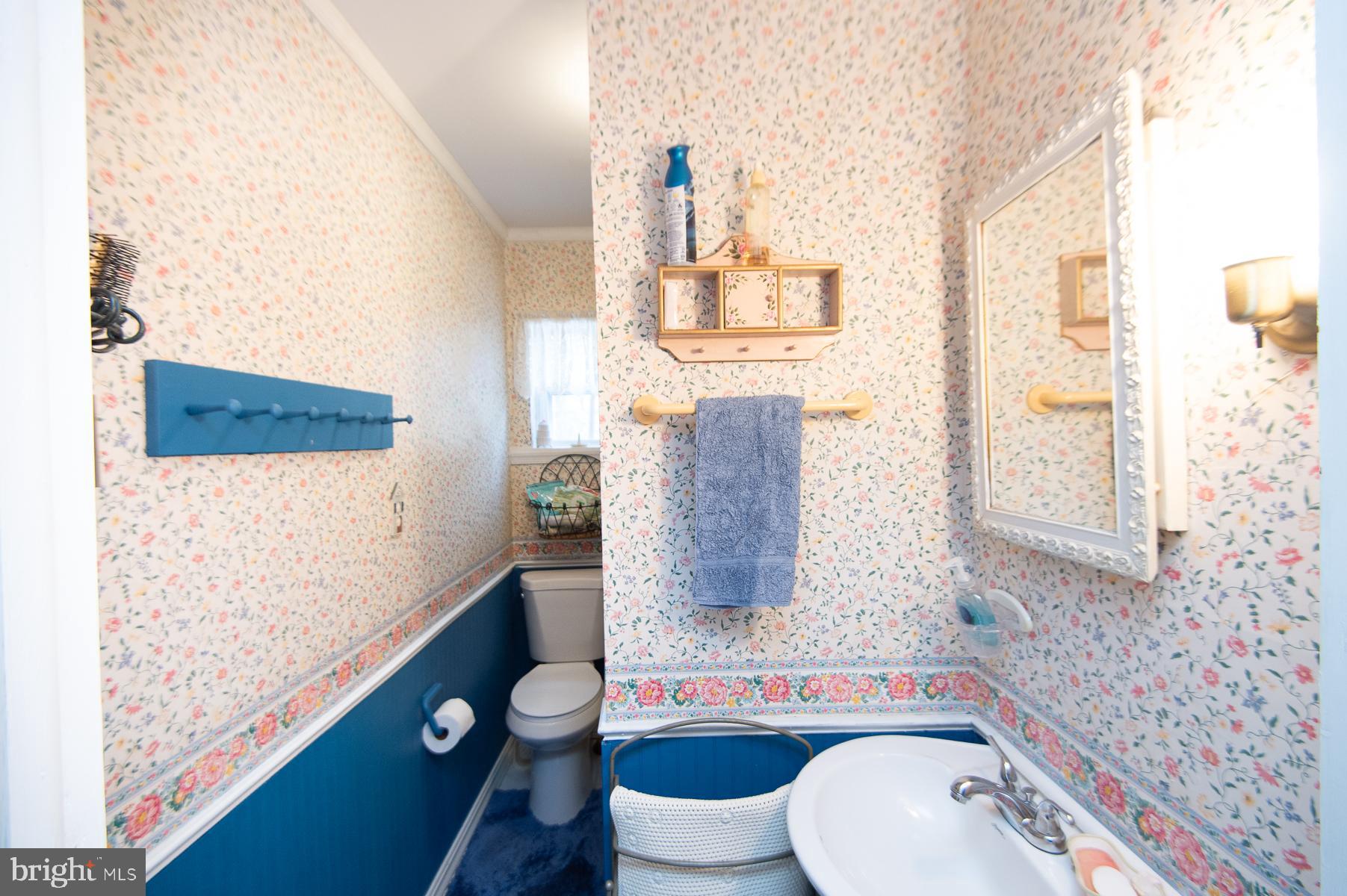 819 Seabreeze Road Cambridge, MD 21613 - Photo 14 of 31 a bathroom with a sink toilet and mirror
