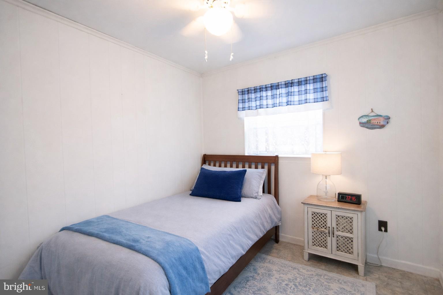819 Seabreeze Road Cambridge, MD 21613 - Photo 15 of 31 a bedroom with a bed and a window