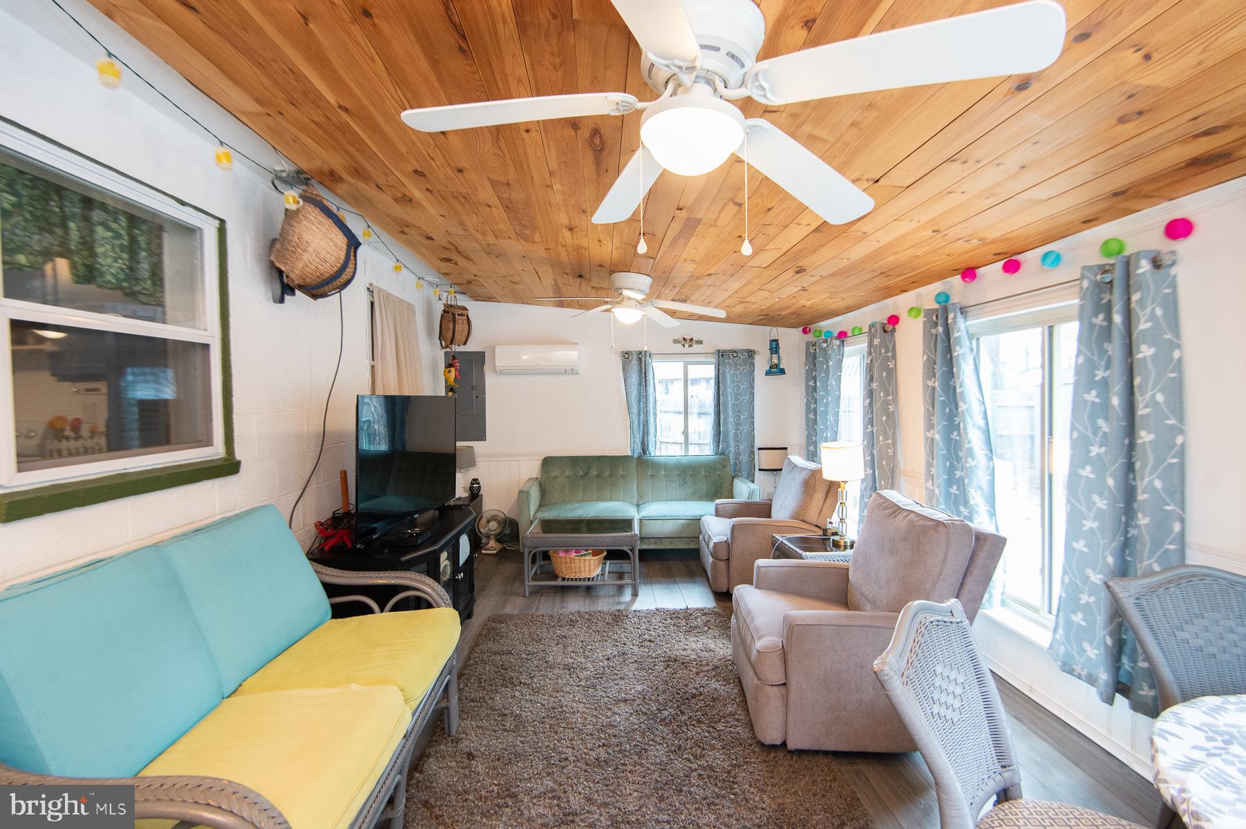 819 Seabreeze Road Cambridge, MD 21613 - Photo 20 of 31 a living room with furniture a ceiling fan and a window