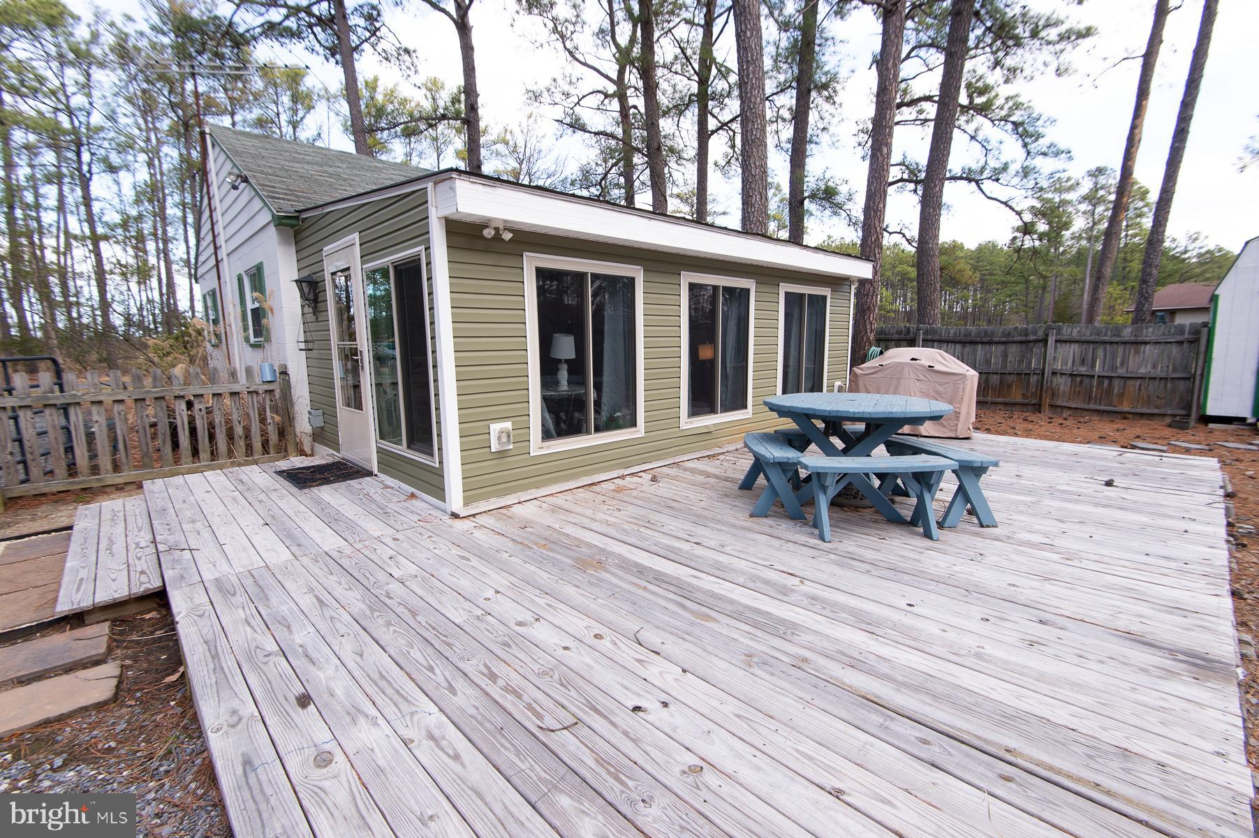 819 Seabreeze Road Cambridge, MD 21613 - Photo 26 of 31 a view of a house with wooden deck and furniture