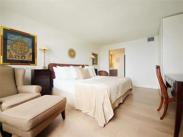 a bedroom with a bed and a night stand