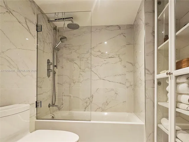 a bedroom with a bed and lamp