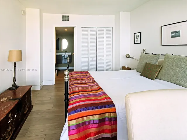 a bedroom with a bed and a lamp