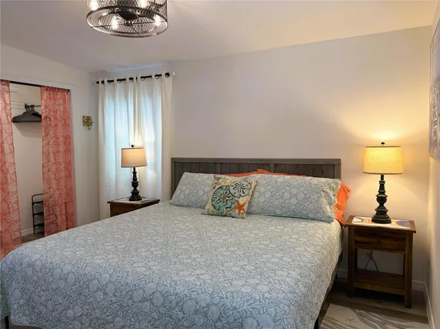 a bedroom with a bed and a chandelier