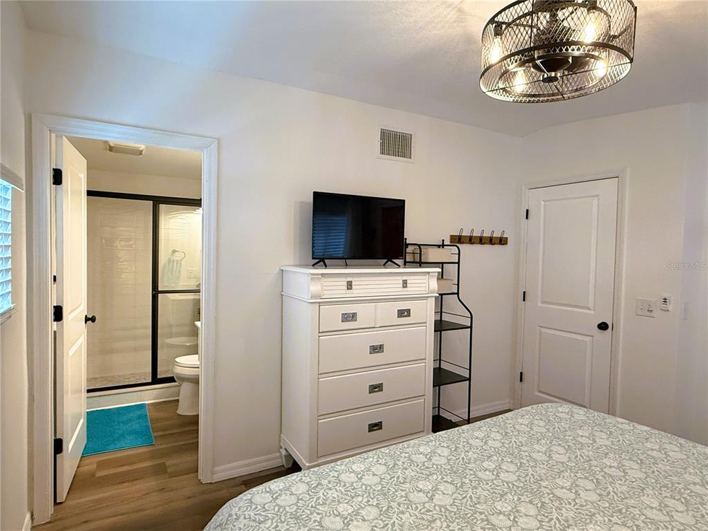 12507 Cortez Road West, Unit 19 Cortez, FL 34215 - Photo 13 of 31 a bedroom with a bed and a television