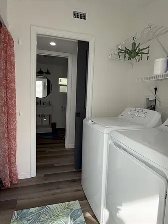 a view of a hallway with a washer and dryer