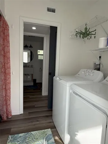 a view of a hallway with a washer and dryer