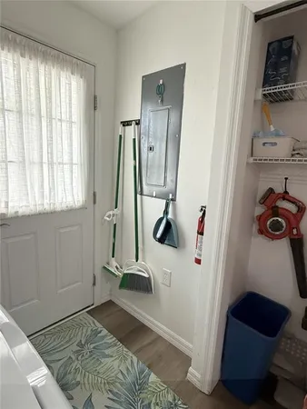 a view of a bedroom with wooden floor and a window