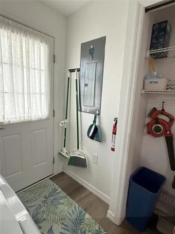 a view of a bedroom with wooden floor and a window