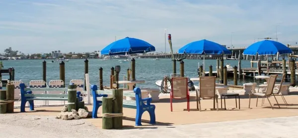 a group of lawn chairs under an umbrella