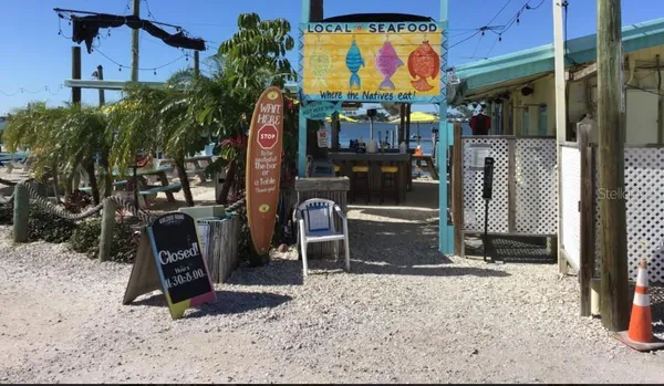a front view of a building with glass windows and a table