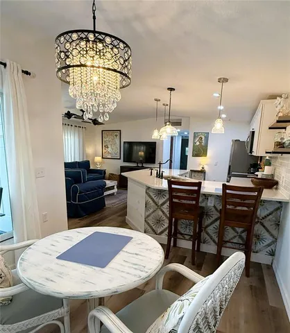 a kitchen with a dining table and chairs