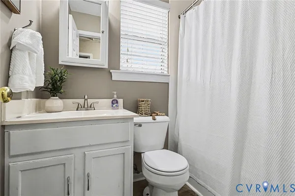 a bathroom with a sink toilet and a mirror