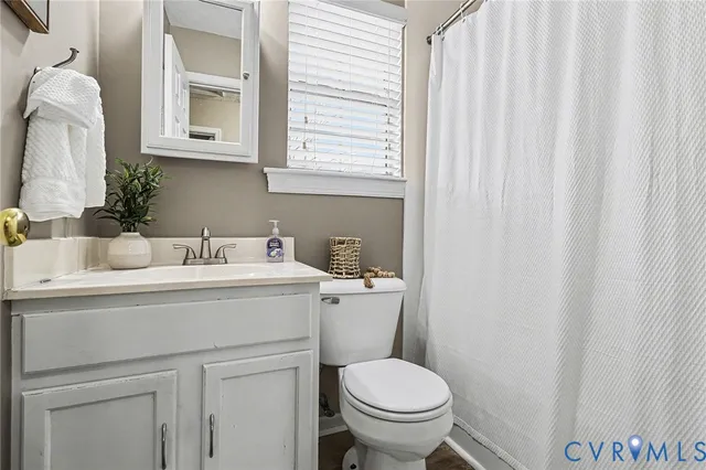 a bathroom with a sink toilet and a mirror