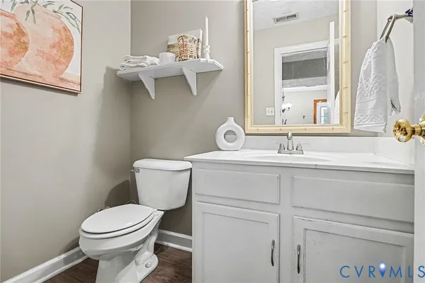 a bathroom with a sink and mirror with toilet