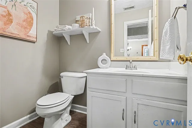 a bathroom with a sink and mirror with toilet