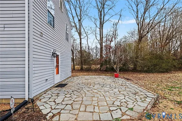 a pathway to a house with a yard
