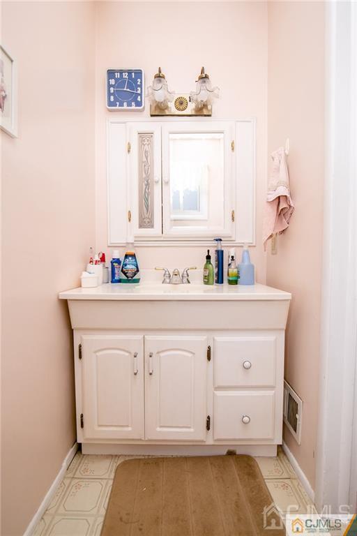 7 Columbia Road Old Bridge, NJ 08859 - Photo 16 of 25 a bathroom with a sink and a mirror