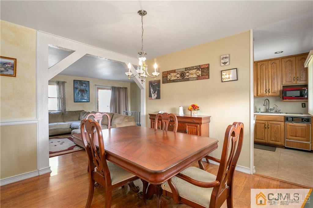 7 Columbia Road Old Bridge, NJ 08859 - Photo 9 of 25 a dining room with furniture a chandelier and wooden floor