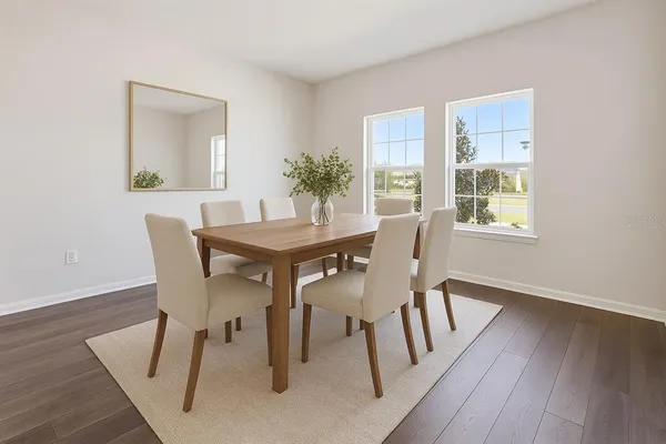 a dining room with furniture and wooden floor