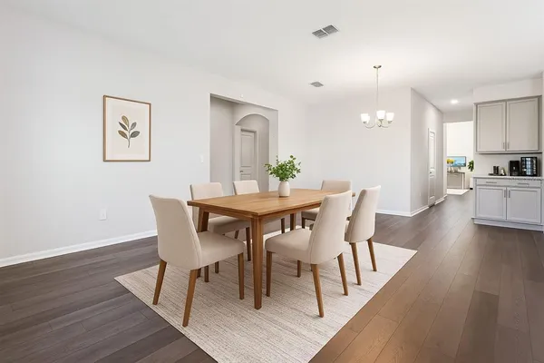 a view of a dining room with furniture and wooden floor