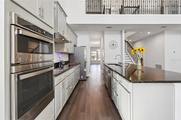 a kitchen with stainless steel appliances granite countertop a sink and stove