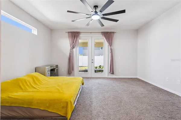 a bedroom with a bed and a large window
