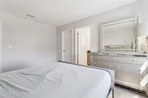 a bedroom with a bed a couch and a window