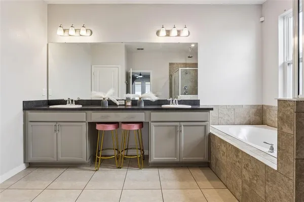 a bathroom with a bathtub a sink and a shower