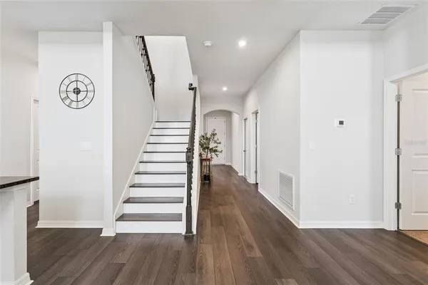 a view of a hallway with wooden floor