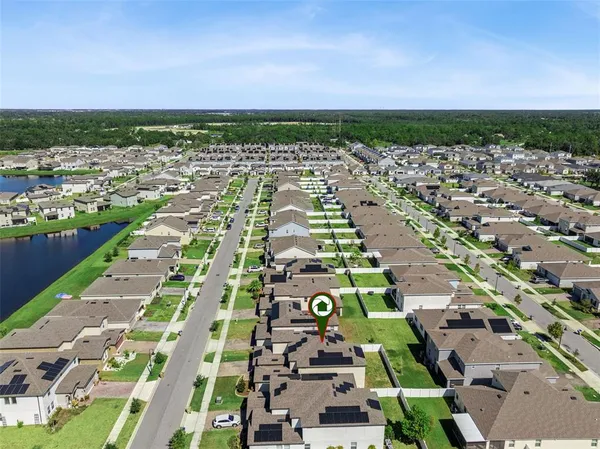 an aerial view of residential houses with outdoor space and river