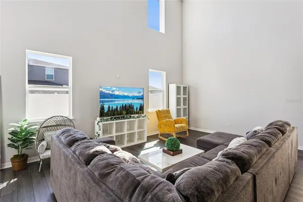 a living room with furniture and wooden floor