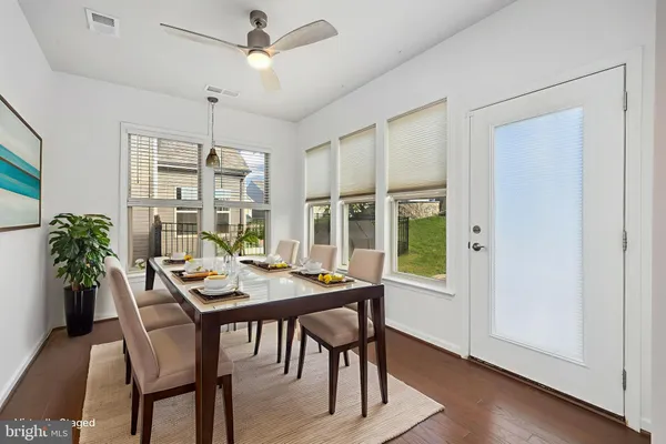 a view of a dining room with furniture window and wooden floor