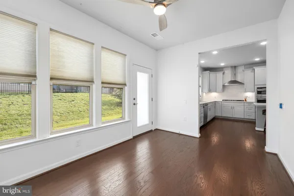 a view of kitchen with wooden floor and windows
