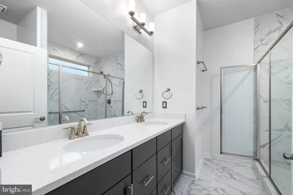 a bathroom with a double vanity sink mirror and double