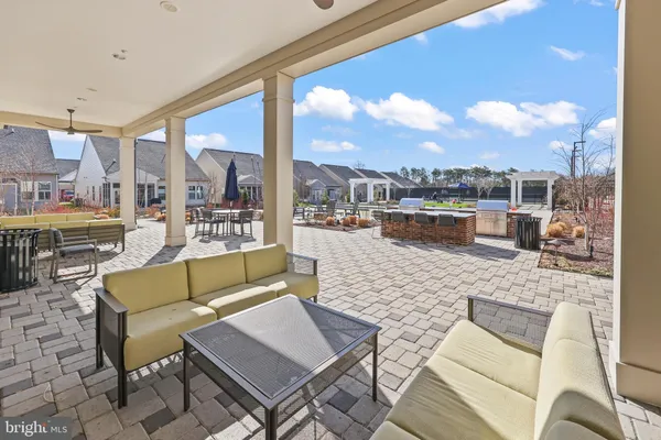 a view of a terrace with furniture and a view of city