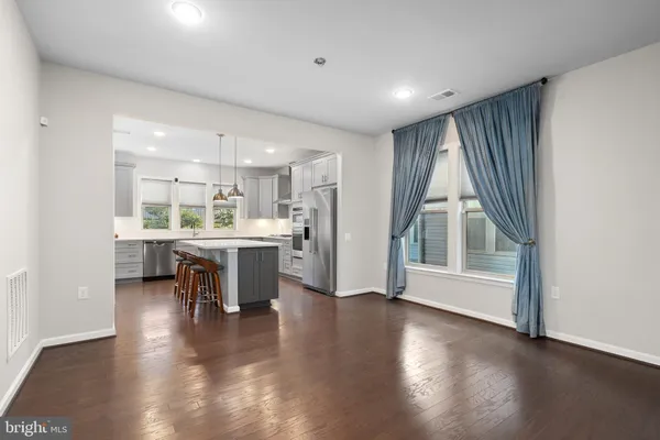 a view of a kitchen with furniture and wooden floor