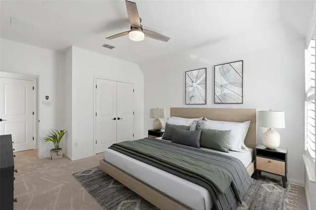 a bedroom with a bed and a chandelier